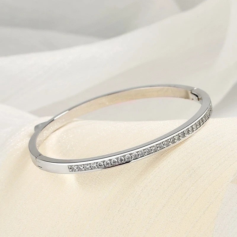 Close-up of minimalist silver bangle with sparkle stones